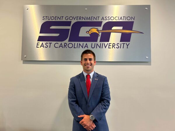 Anderson Ward in front of ECU SGA sign