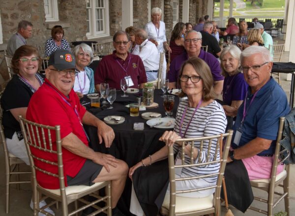 men and women around banquet tables