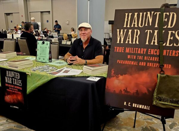 man at book signing table