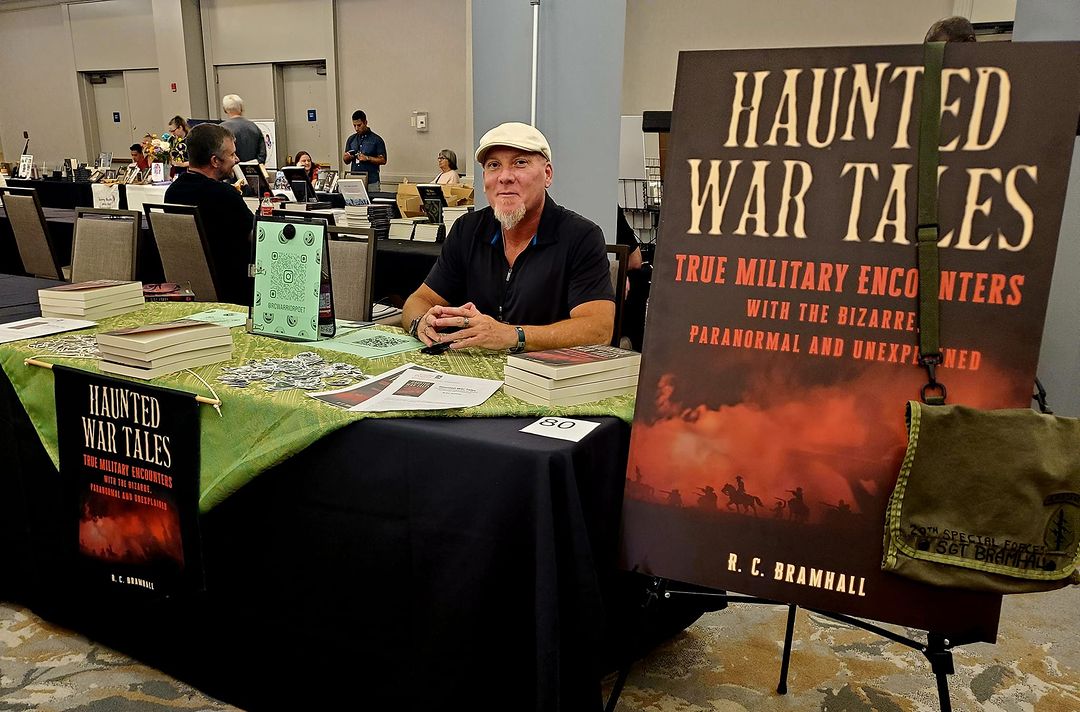 man at book signing table