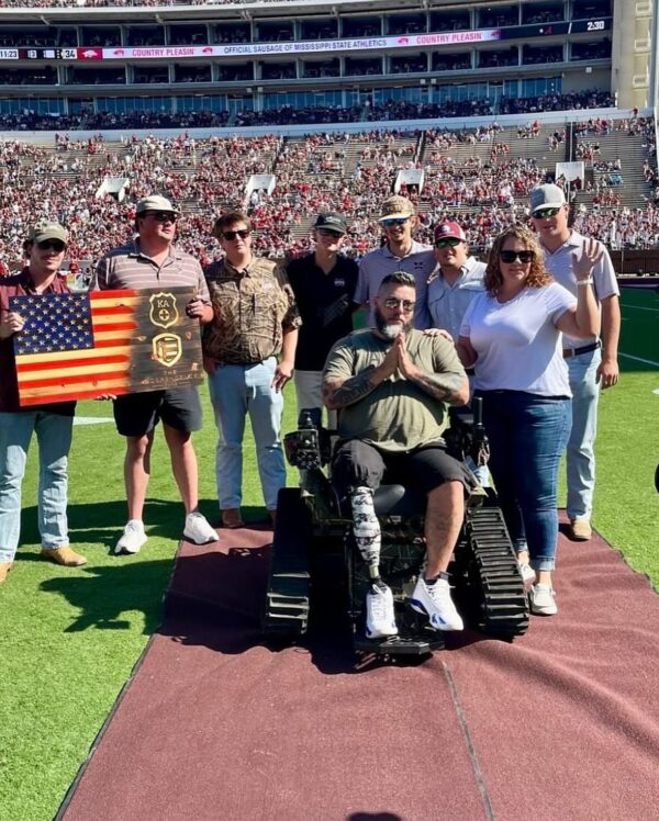 KA members on field with veteran