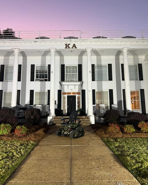 track chair in front of fraternity house