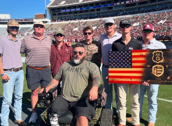 KA members on field with veteran