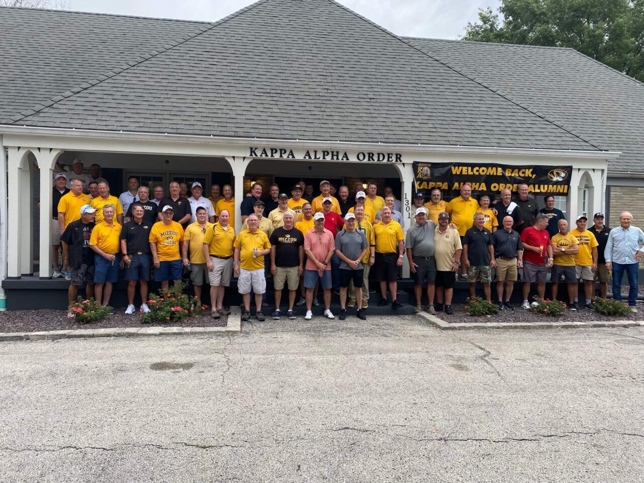 group of men in yellow shirts at KA house