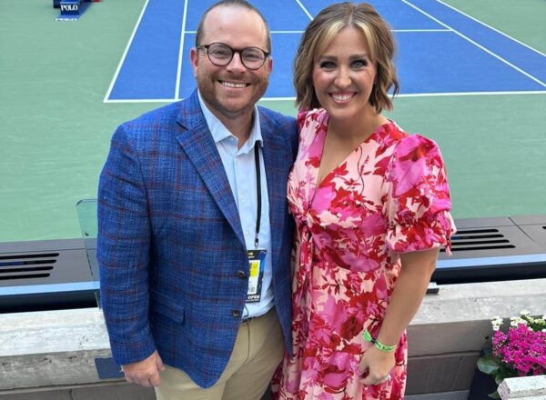 man and woman at tennis match