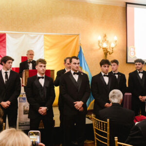 young men in suits receiving officer jewel