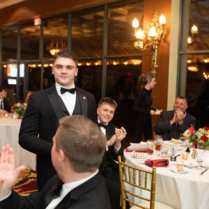 audience applauding young man in suit standing