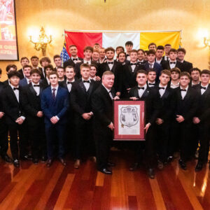 group photo of young men in tuxes with framed charter