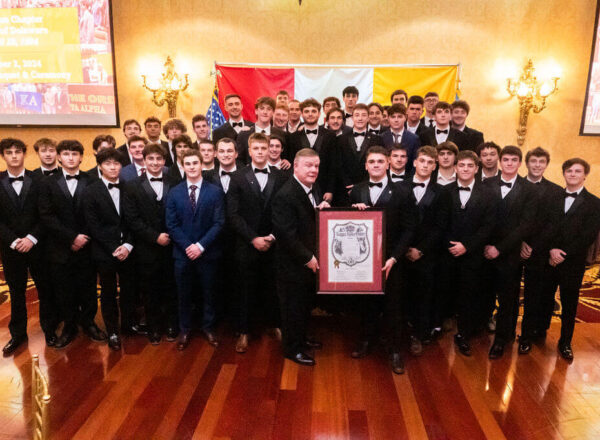 group photo of young men in tuxes with framed charter