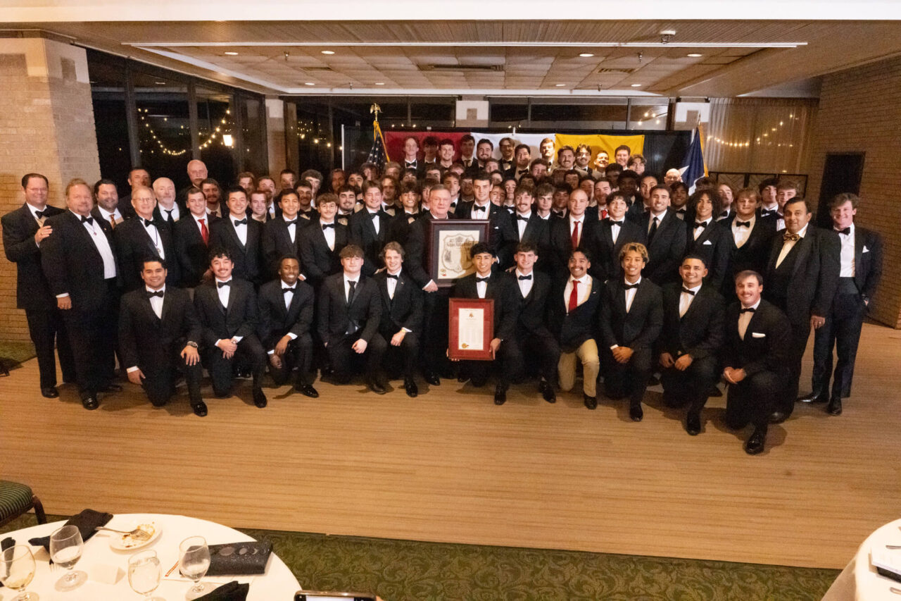 large group of young and older men in tuxes