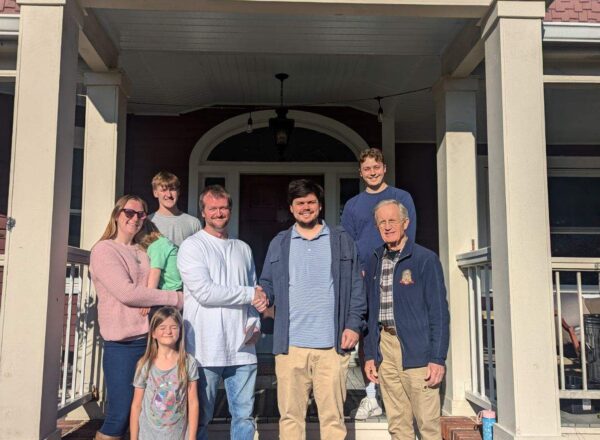 family on front porch of KA house