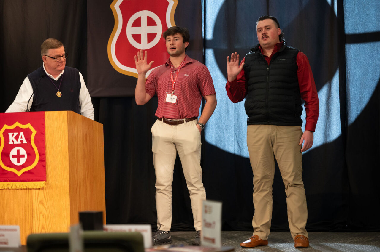 two men holding right hand up and reciting oath of office