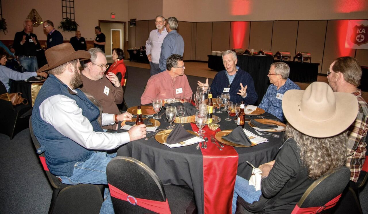 men and women around banquet table