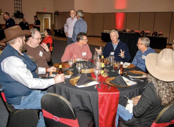 men and women around banquet table