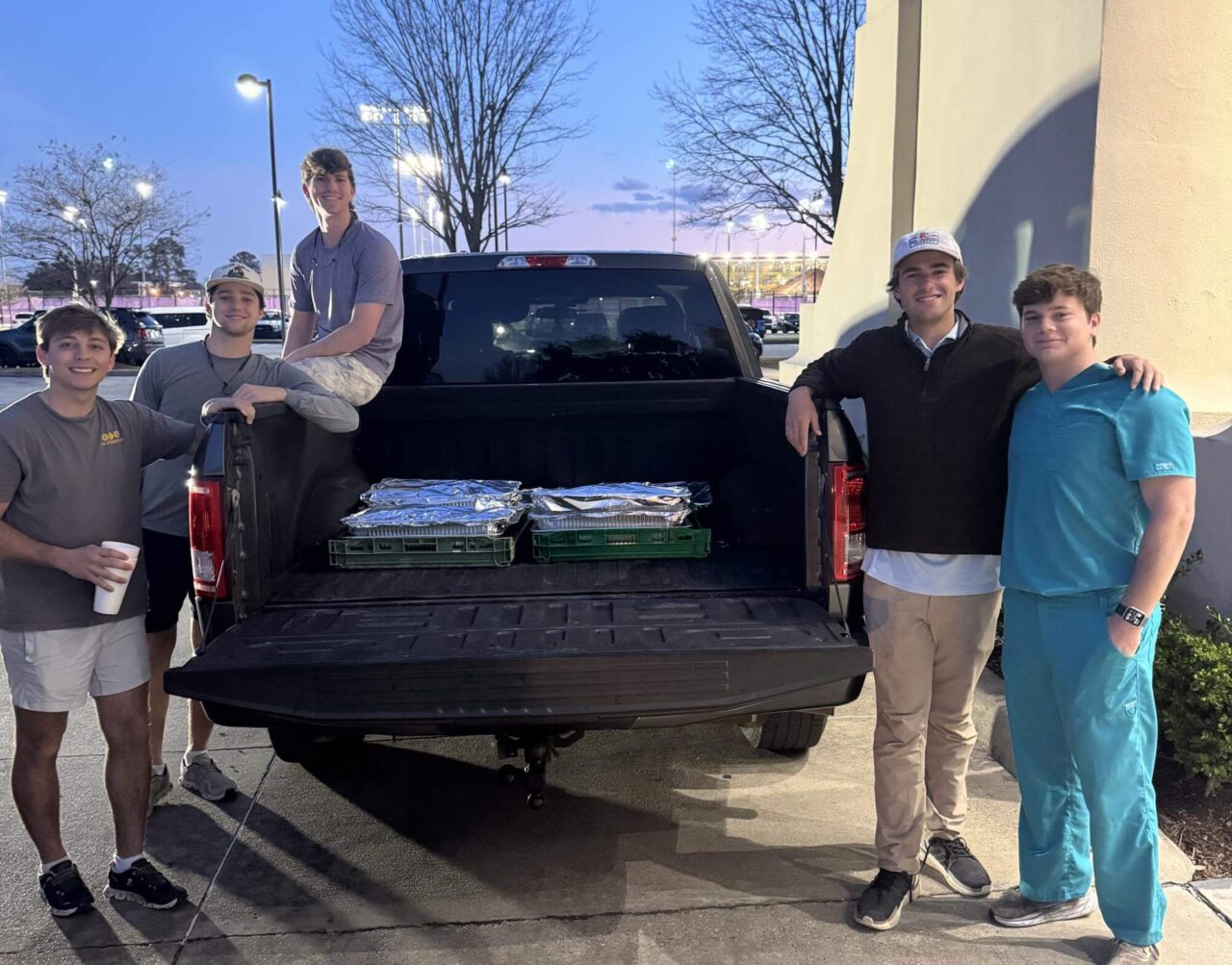 young men with truck bed of food