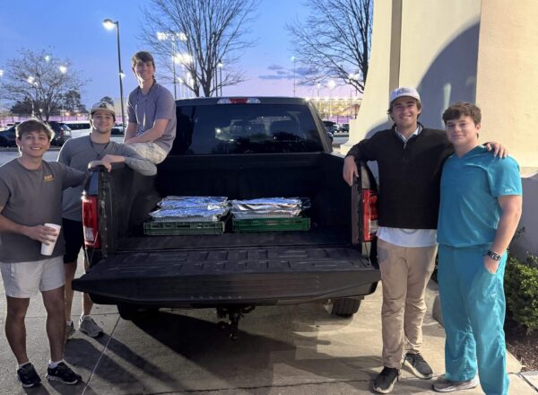 young men with truck bed of food