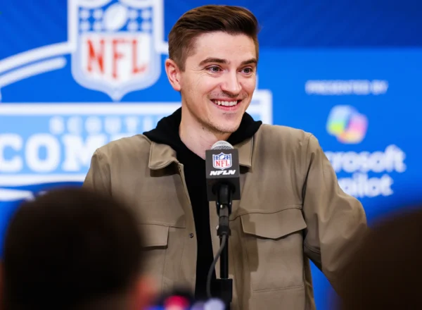 man in front of microphone at press conference